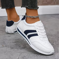 White low-top trainers with navy stripes, round toe and lace-up fastening