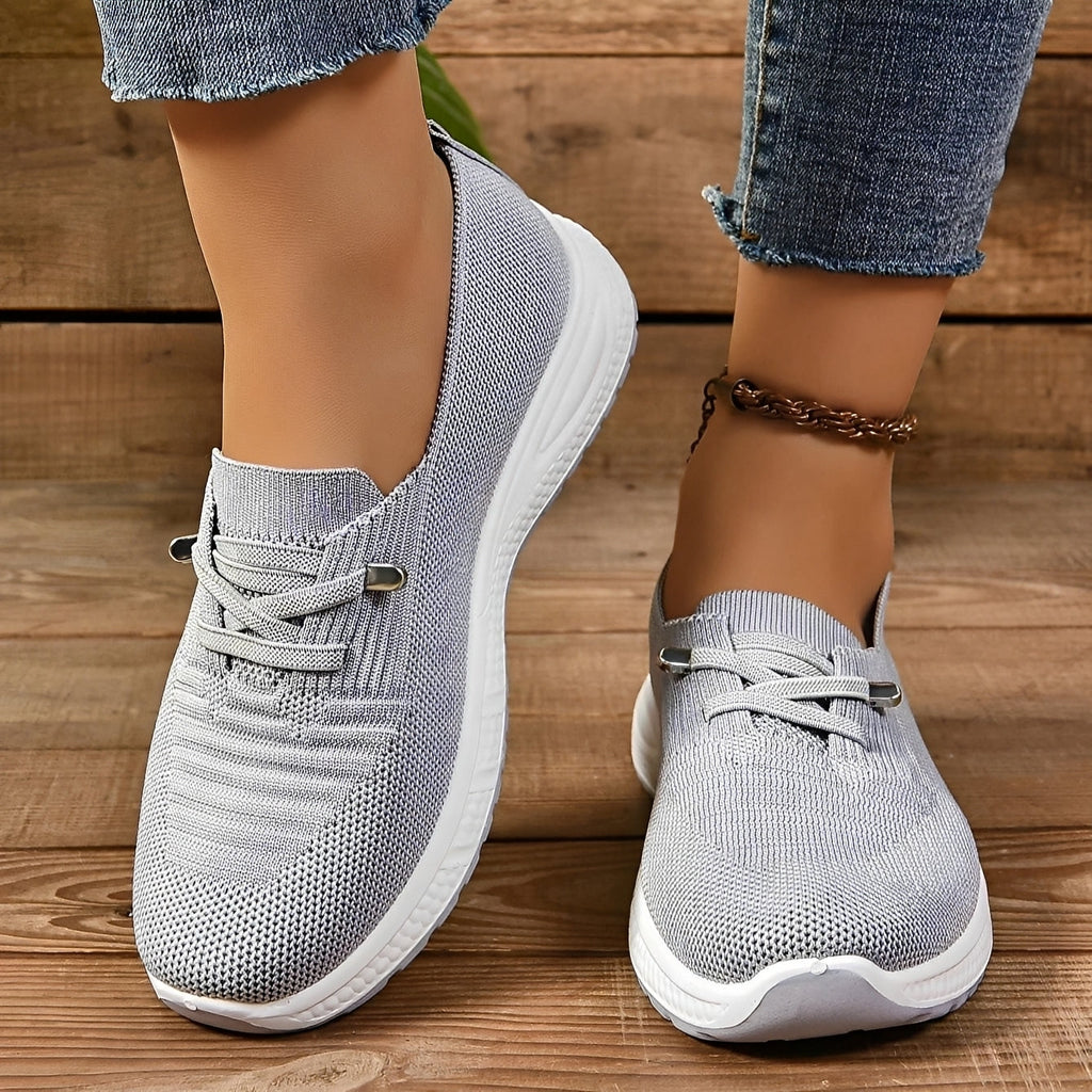 Women's grey textured lace-up trainers with round toes and white flat soles
