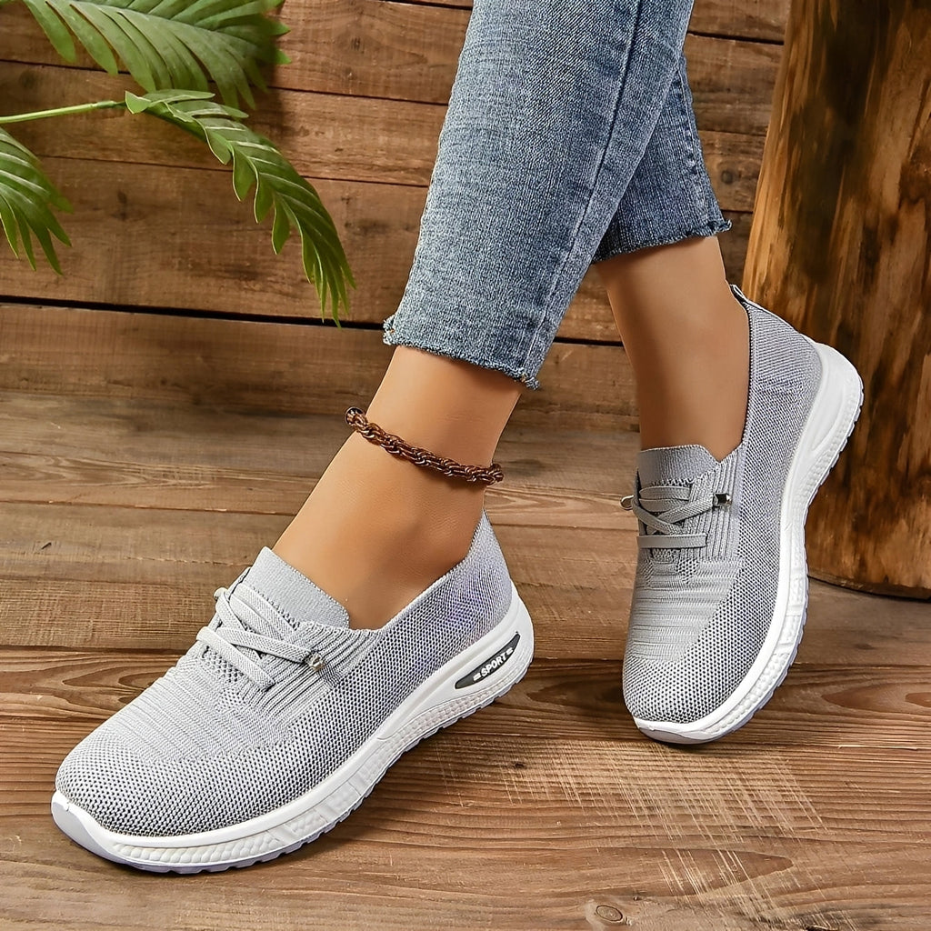 Women's grey textured lace-up trainers with round toes and white flat soles