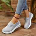 Women's grey textured lace-up trainers with round toes and white flat soles