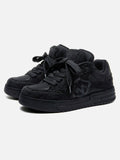 Black high-top skate trainers with lace-up front and tonal camouflage side detail