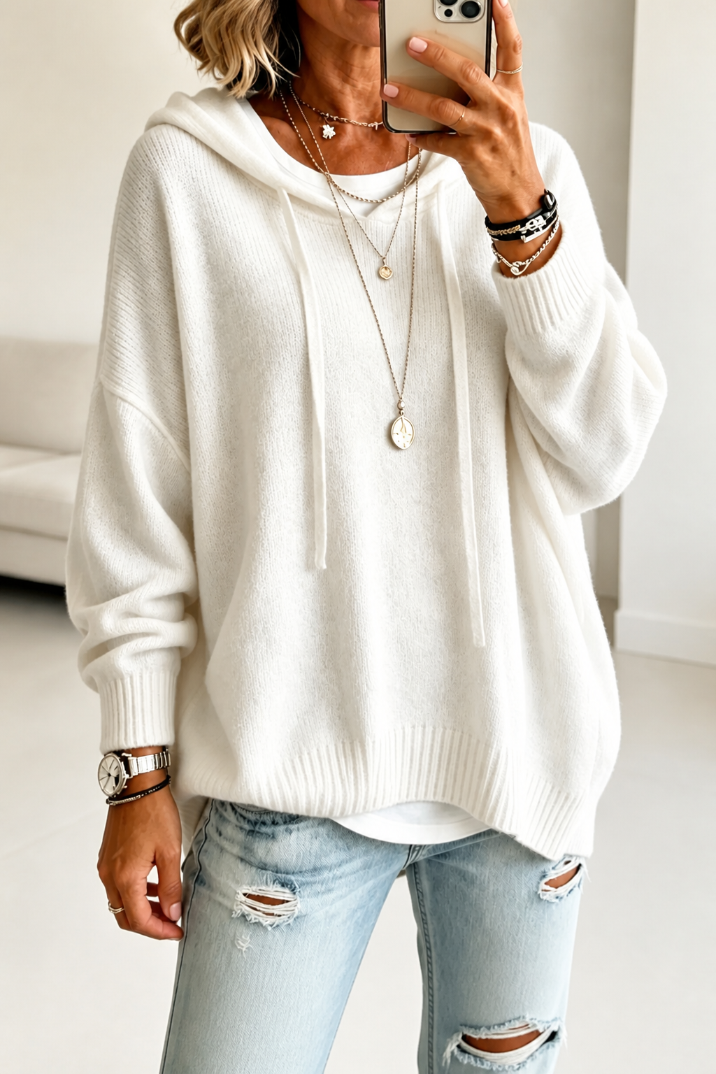 Women's oversized hooded knit sweater with drawstring ties and ribbed edges