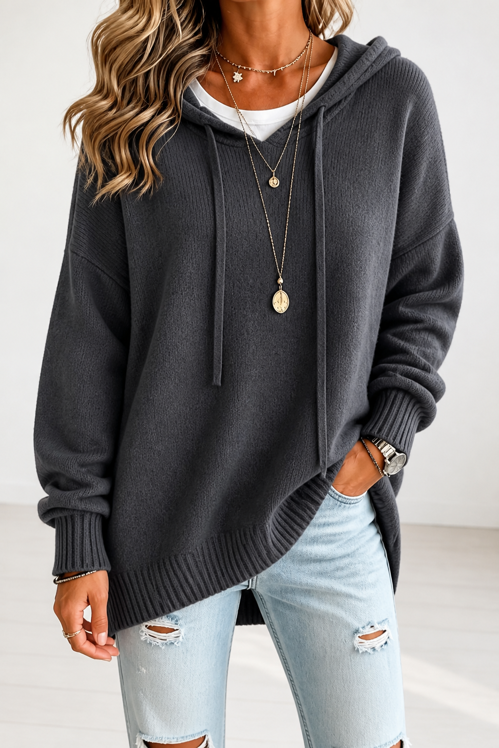 Women's oversized hooded knit sweater with drawstring ties and ribbed edges